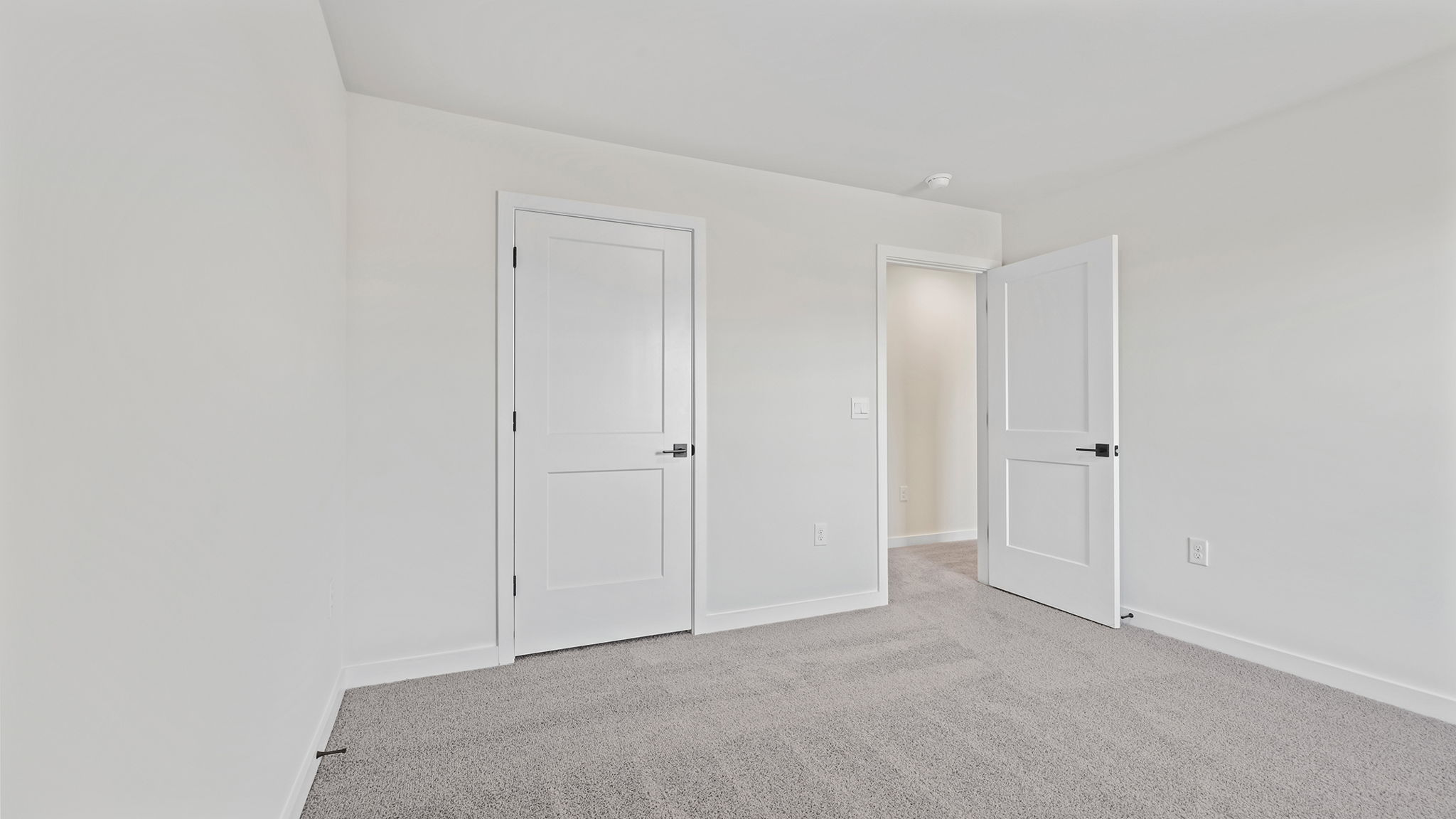 Bedroom with window and carpet.