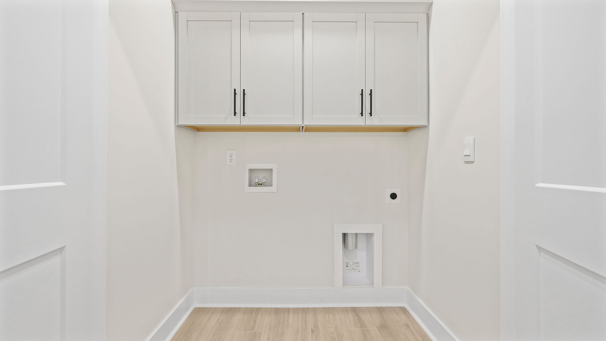 Walk-in laundry room with shelving.