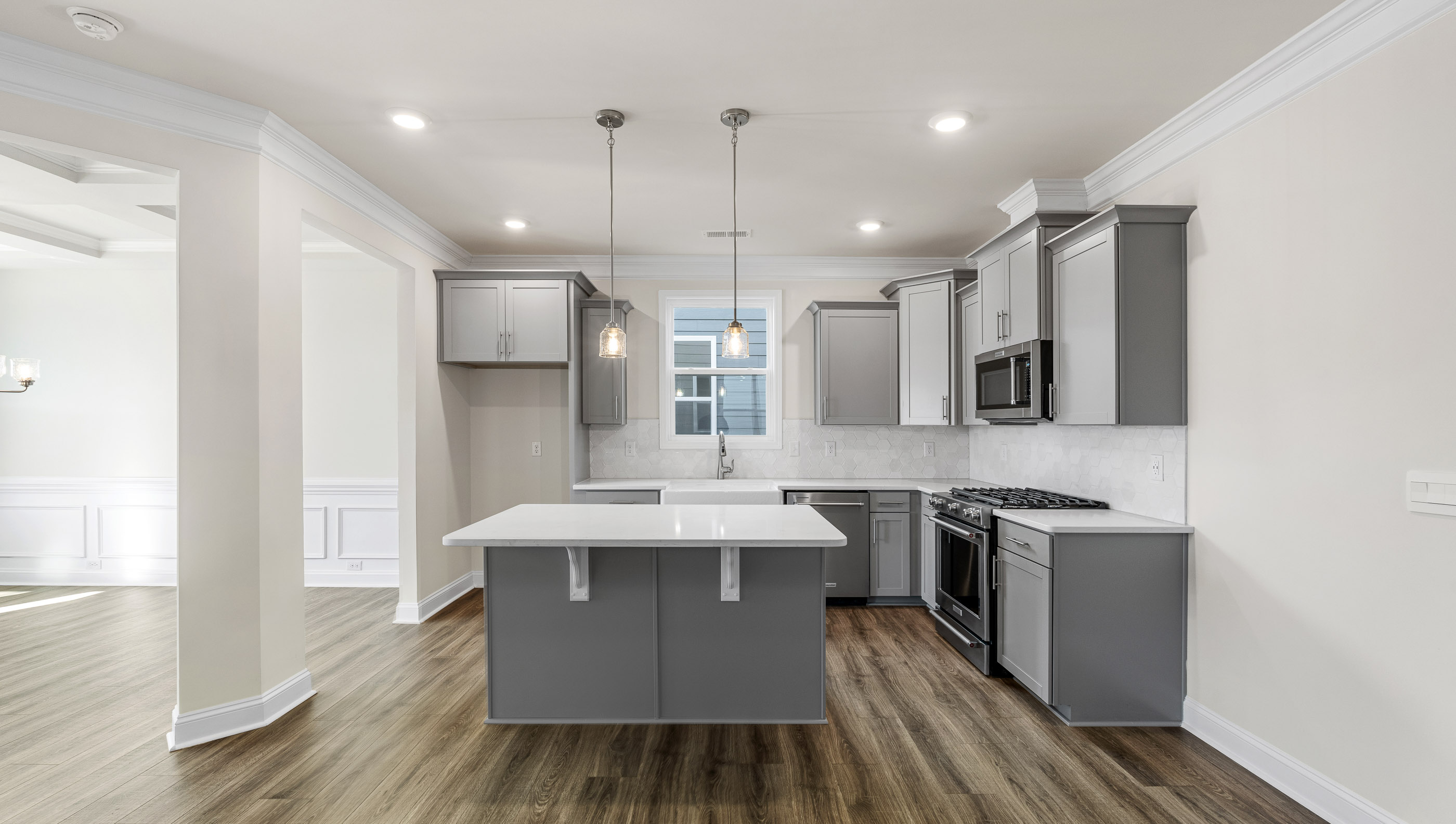 Kitchen with island and quartz countertops.