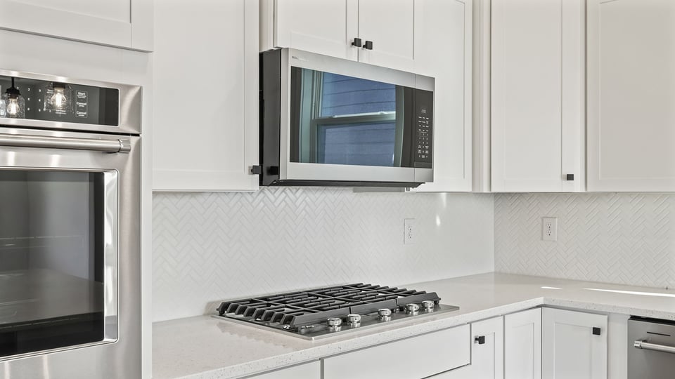 Stainless steel gas cooktop and wall oven.