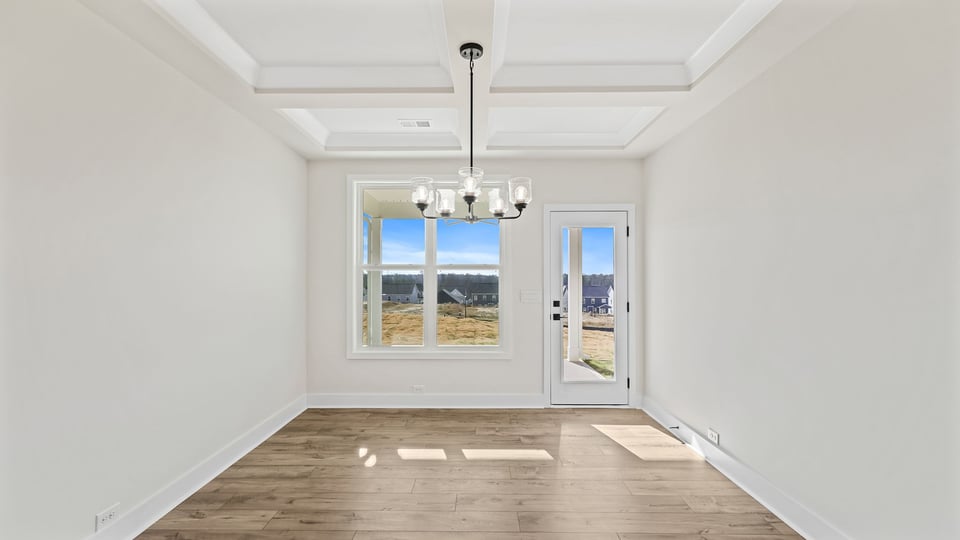 Formal dining room with large window.