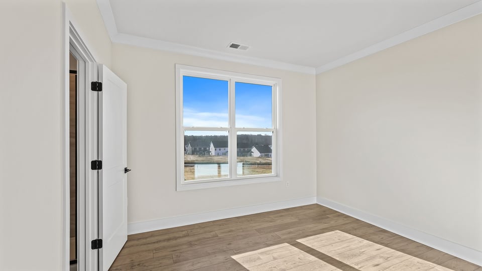 Bedroom on the main level with large window.