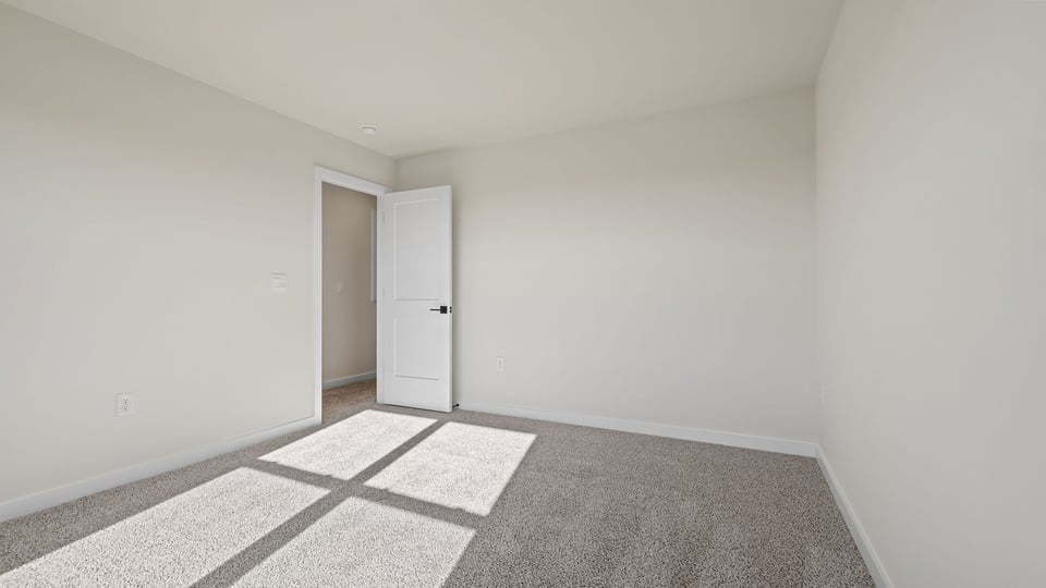 Bedroom with window and carpet.
