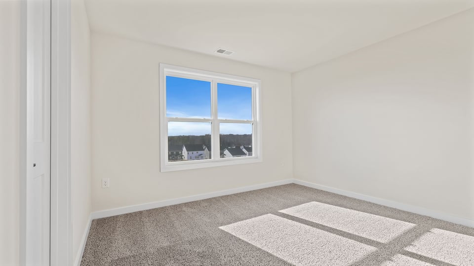 Bedroom with window and carpet.