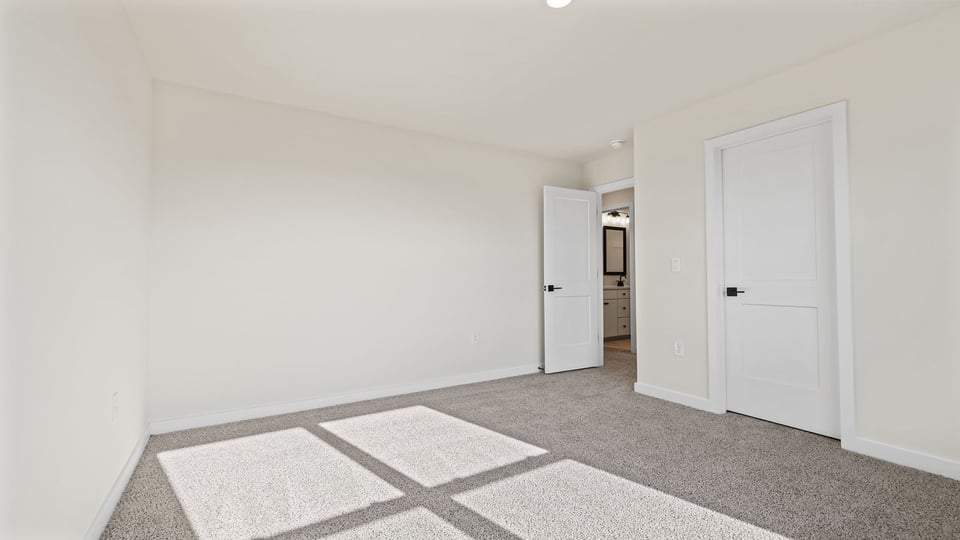 Bedroom with window and carpet.
