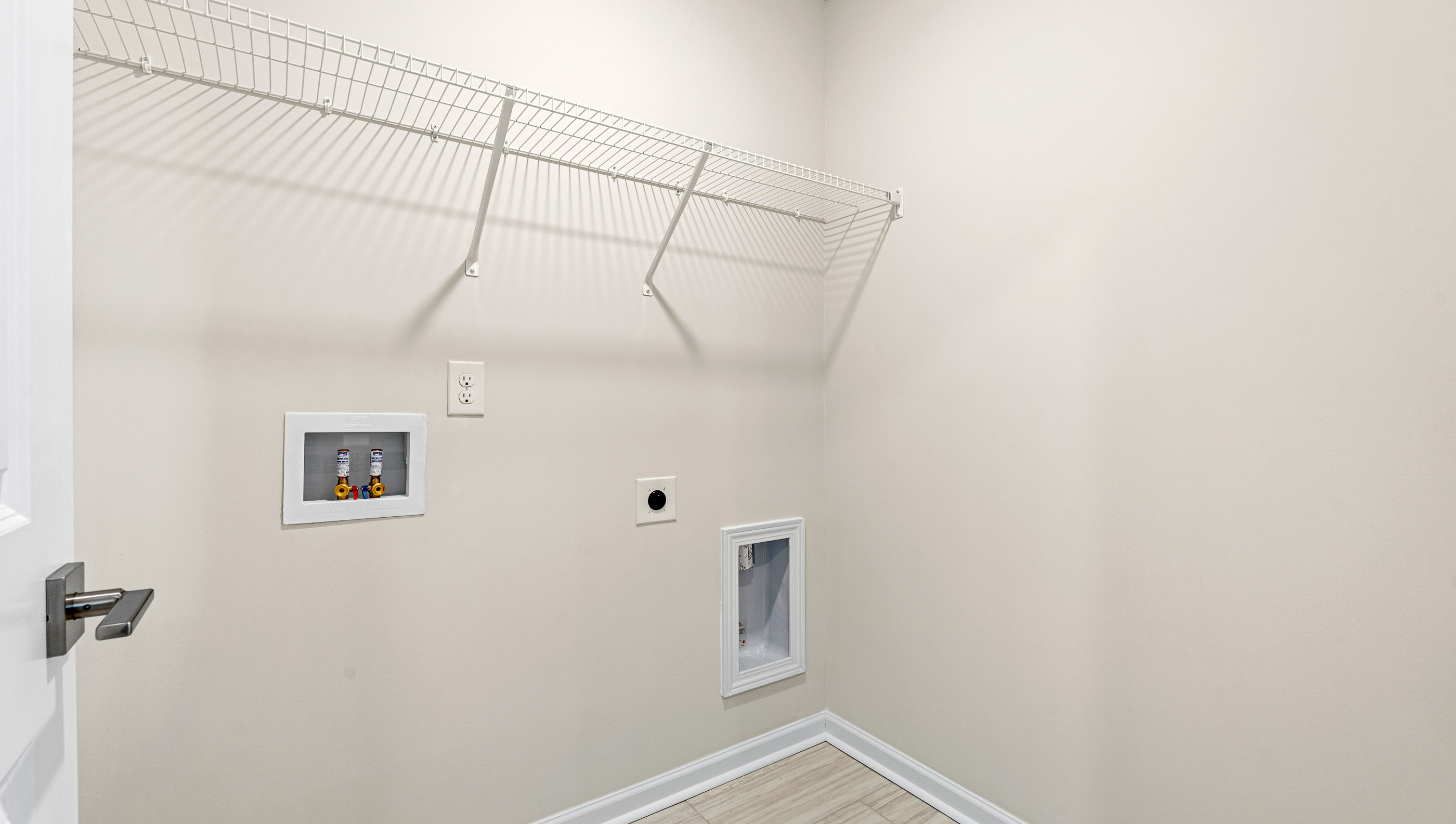 Laundry room with hanging storage racks.
