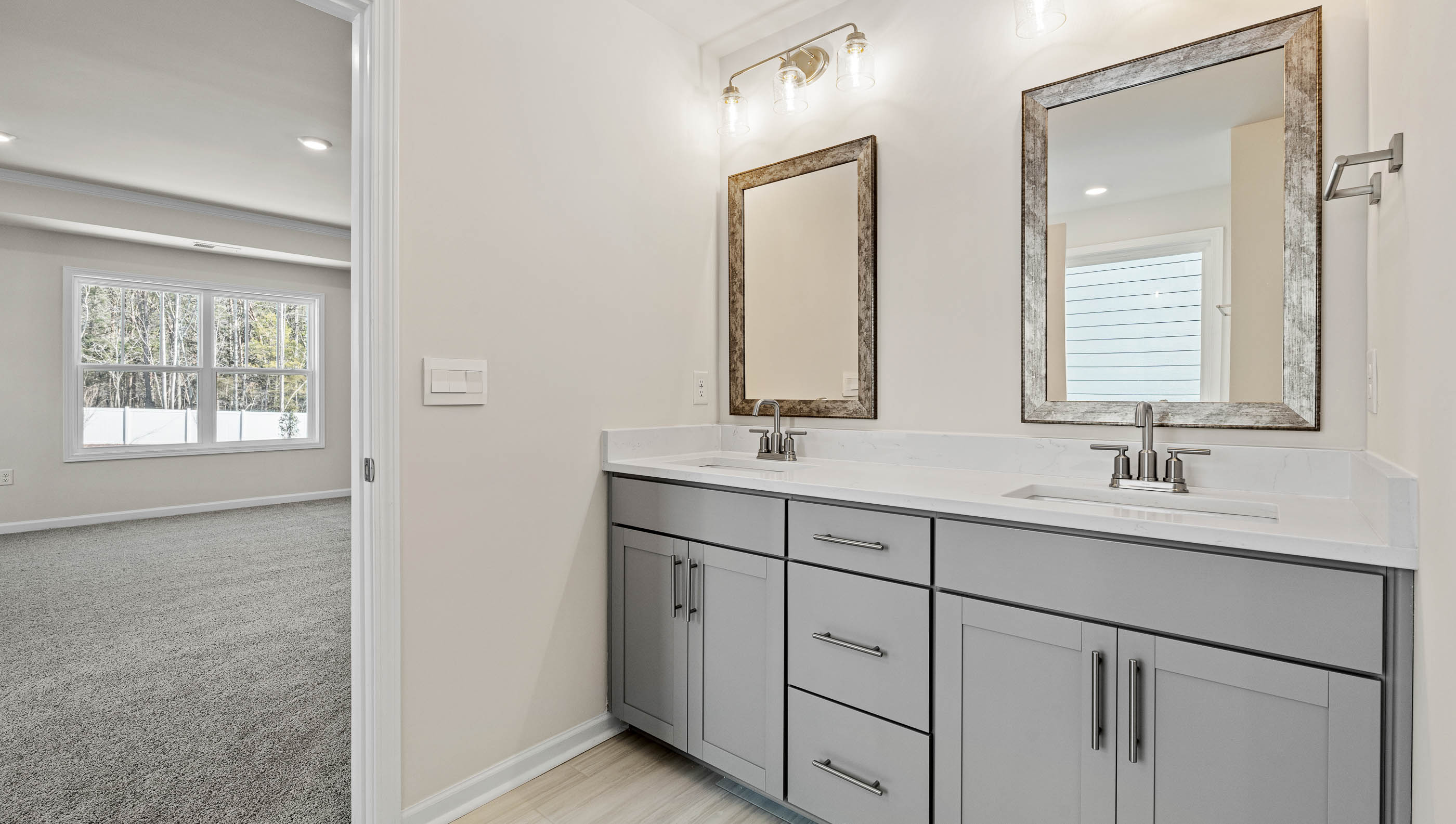 Bathroom with double vanity sink and walk in closet.