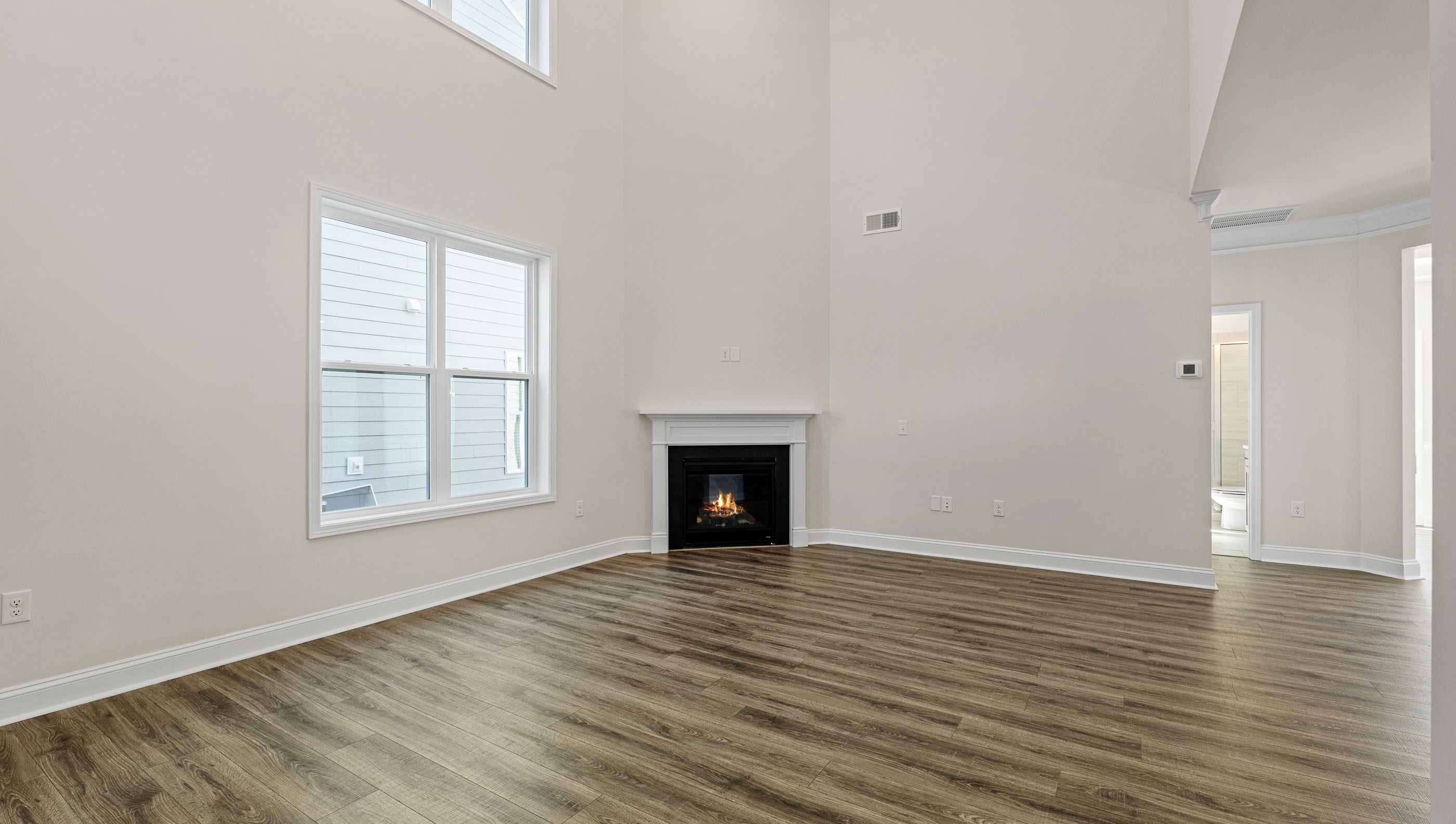 Living area with fireplace and windows.