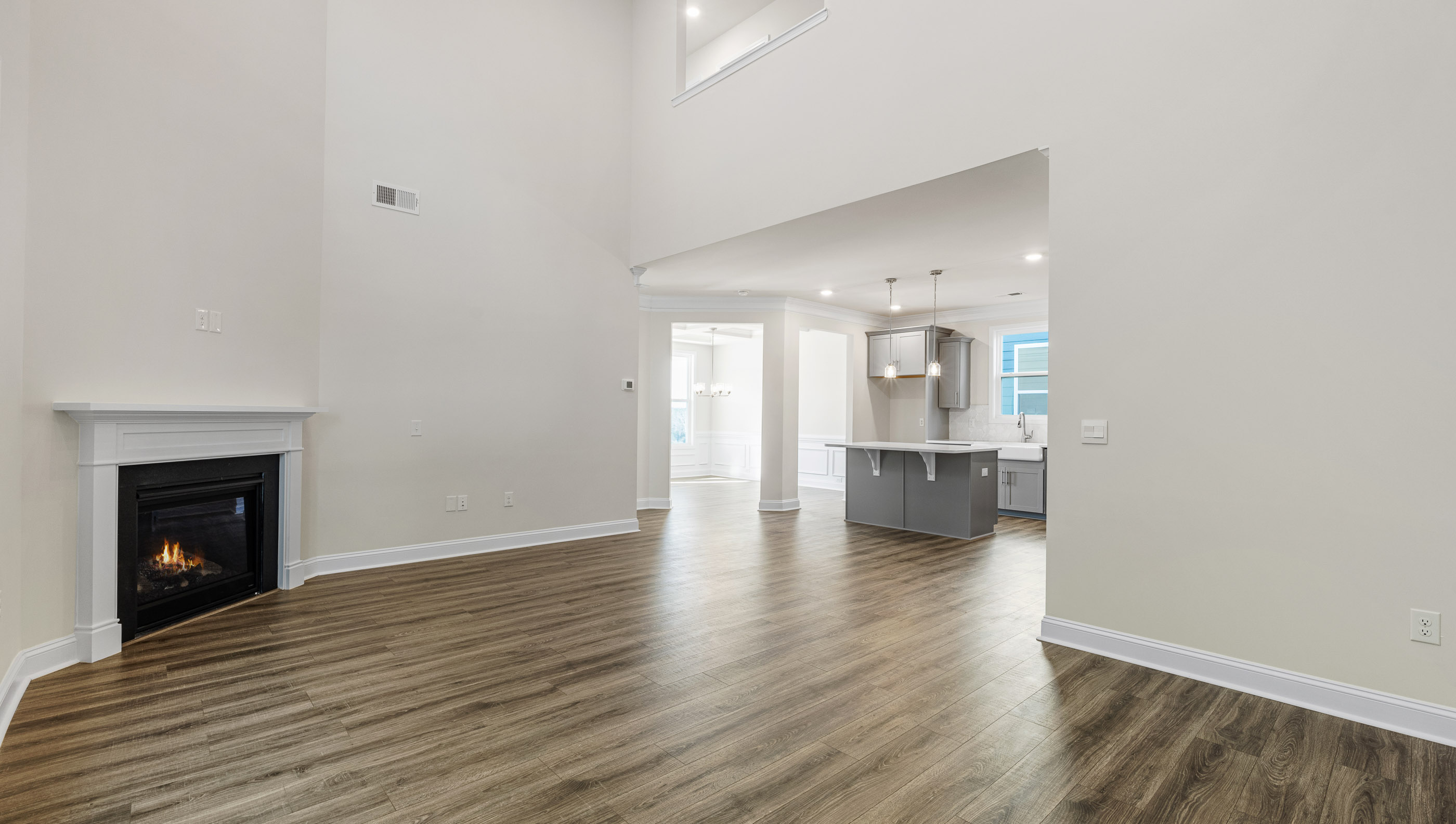 Living area with fireplace and windows.