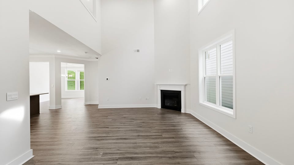 Living room with windows and fireplace.