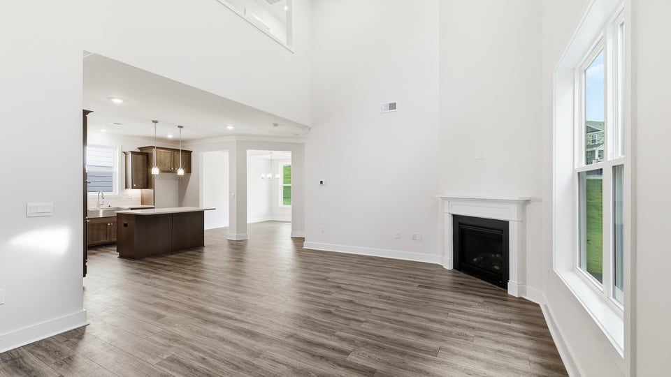 Living room with windows and fireplace.