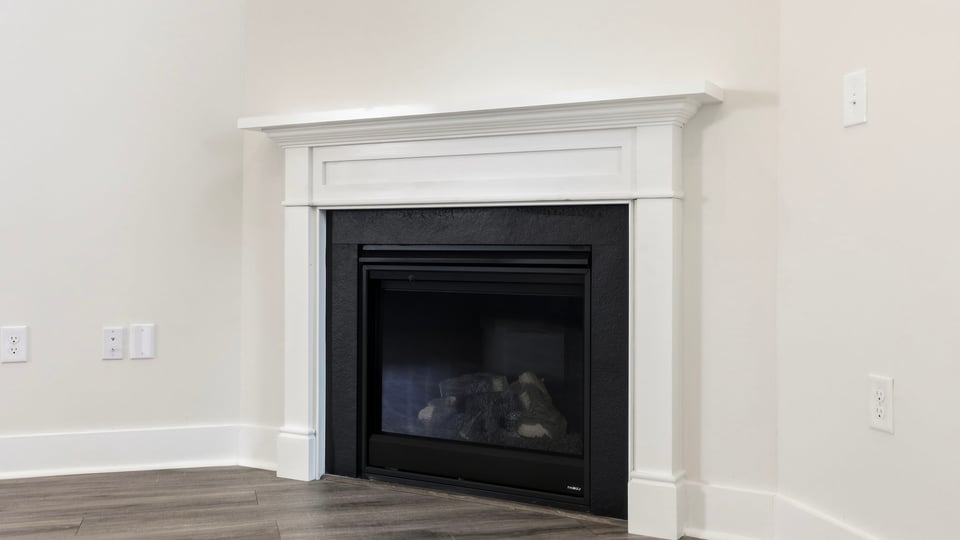 Living room with windows and fireplace.