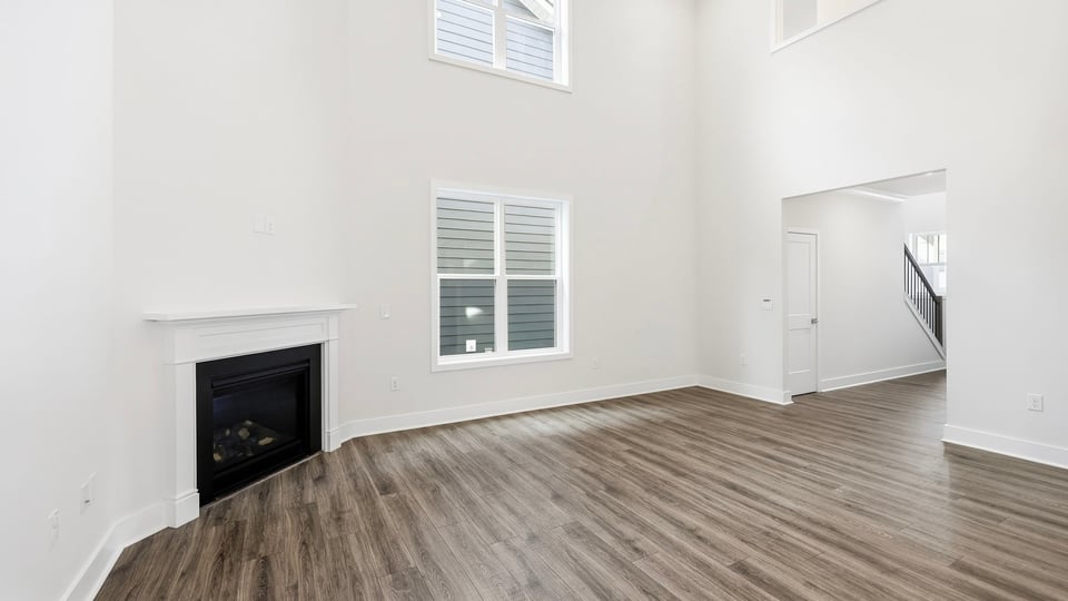 Living room with windows and fireplace.
