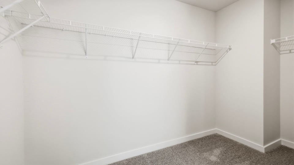 Primary closet with shelf.
