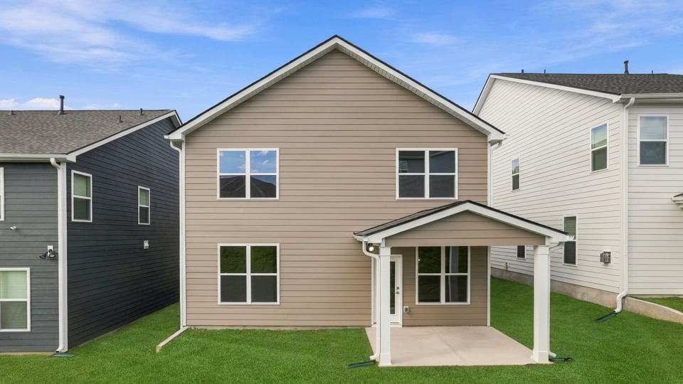 Back exterior with large backyard.