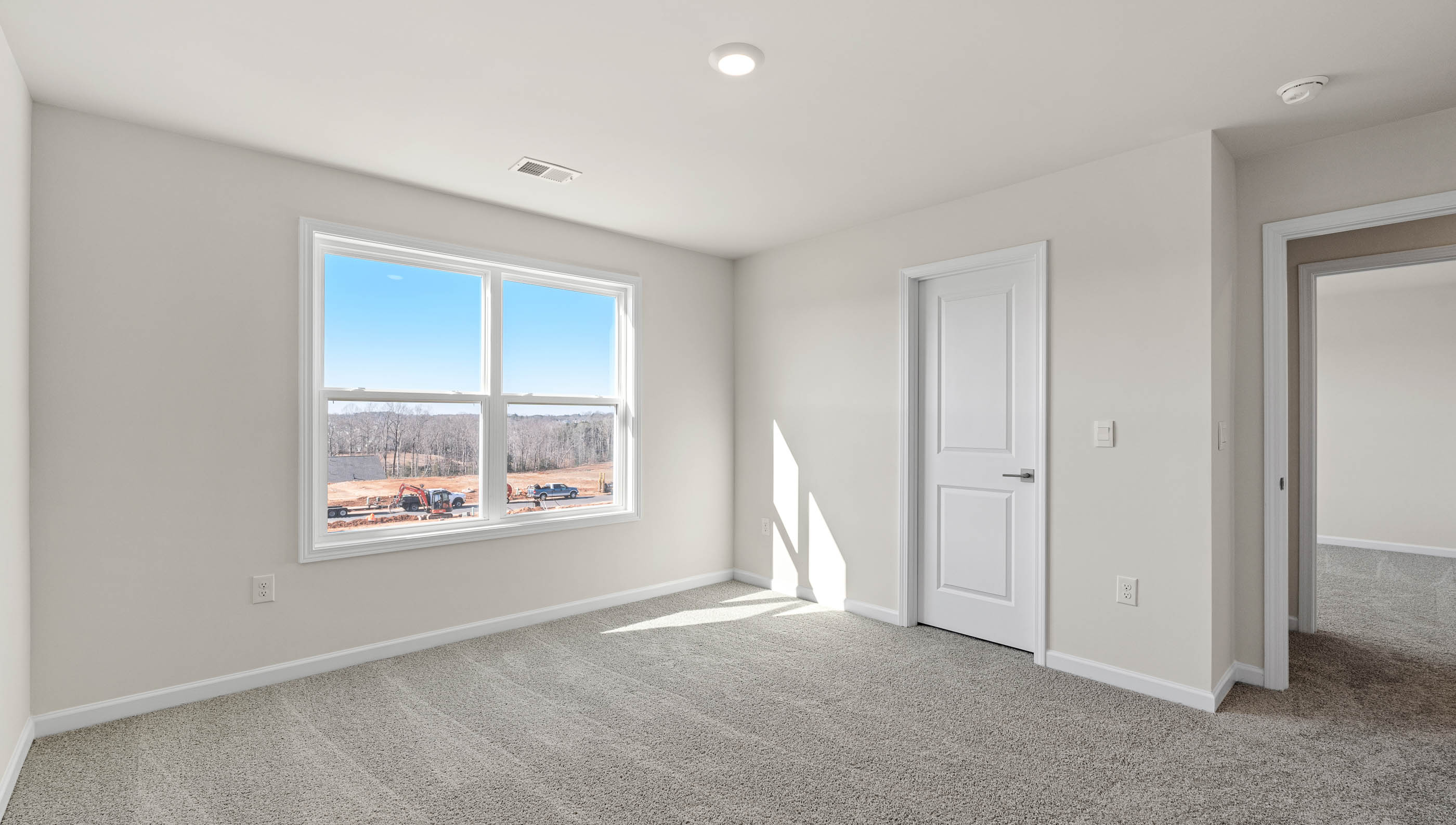 Bedroom with carpet and windows.