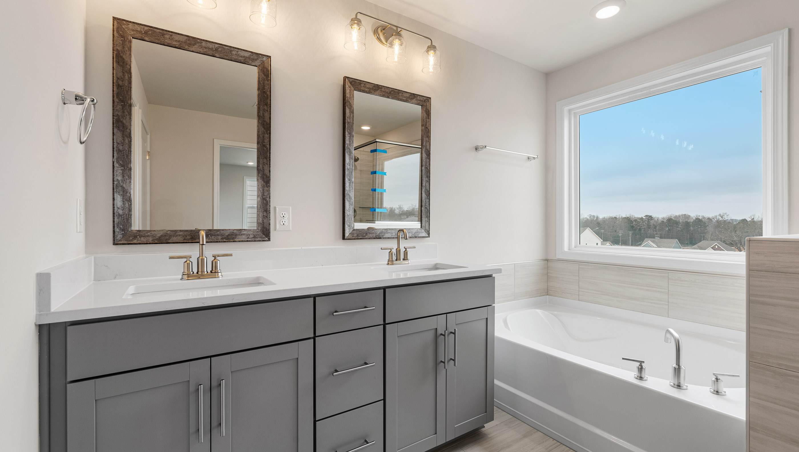 Primary bathroom with dual sink vanity and garden tub.