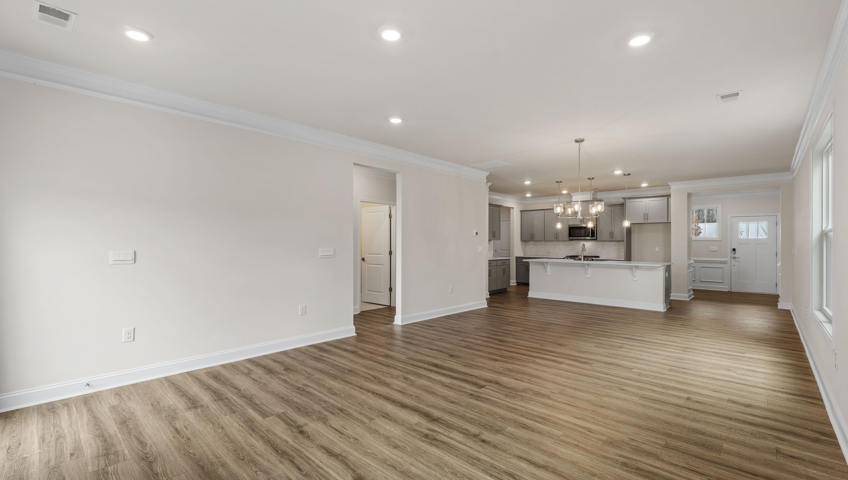 View of living room with windows and fireplace.