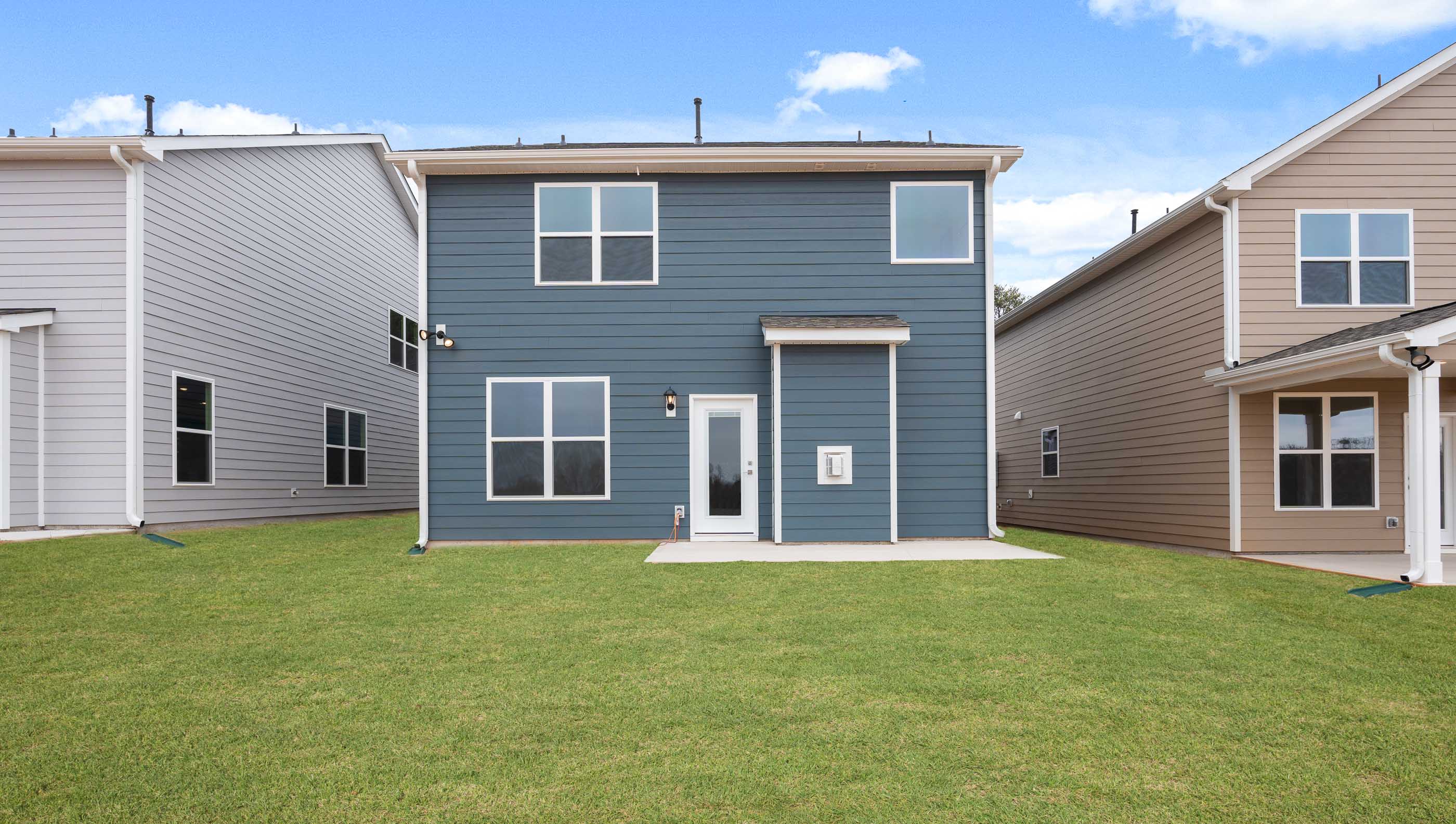 Back exterior of home with large backyard.