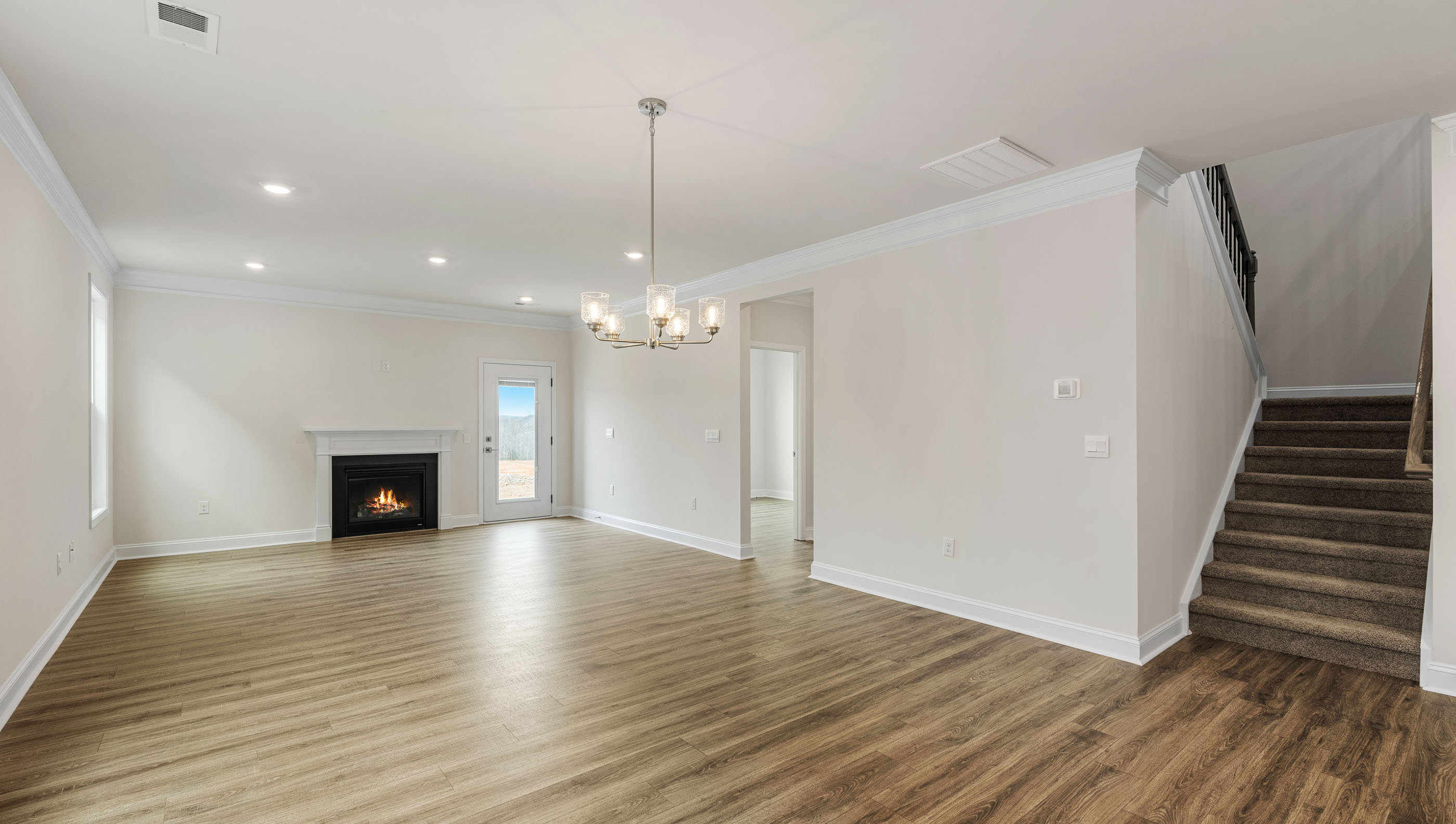 View of living room with windows and fireplace.