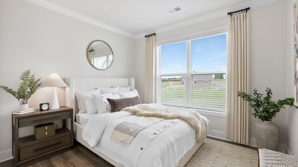 Bedroom with carpet and windows.