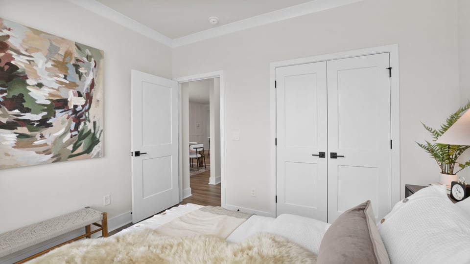 Bedroom with carpet and windows.