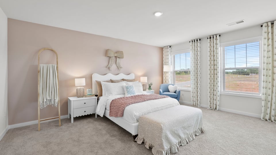 Bedroom with carpet and windows.