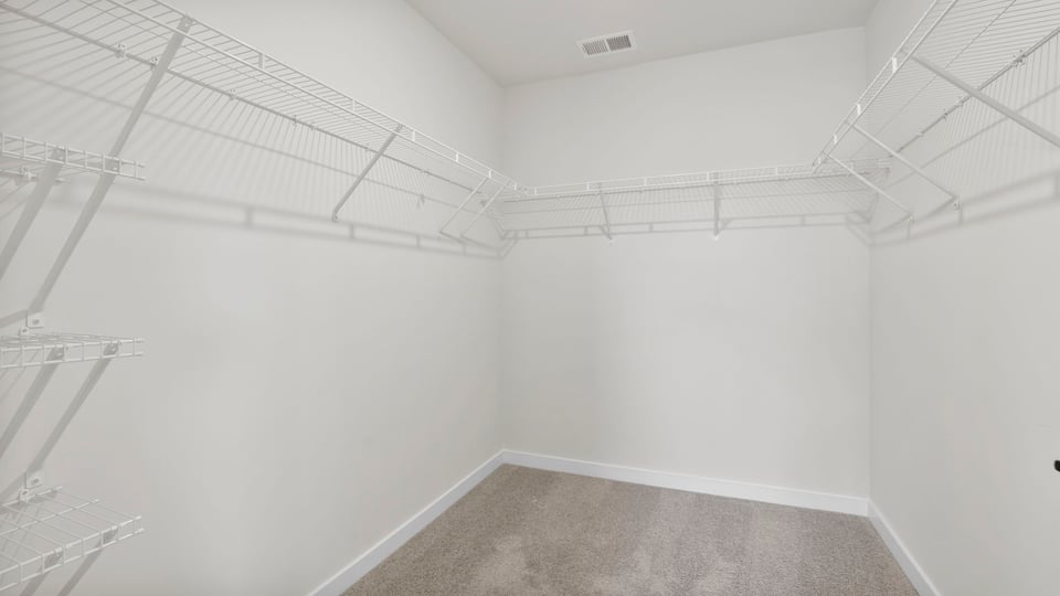Primary closet with shelf.