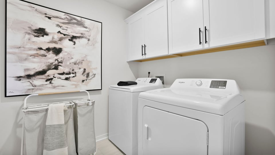 Laundry room with cabinets.