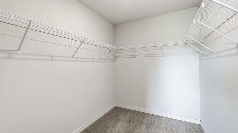 Primary closet with shelf.