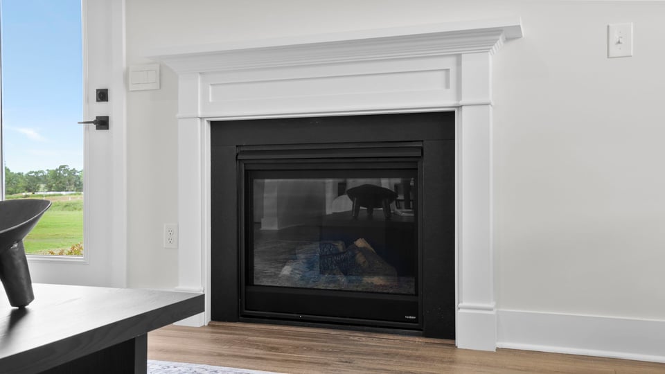 Living area with windows and fireplace.