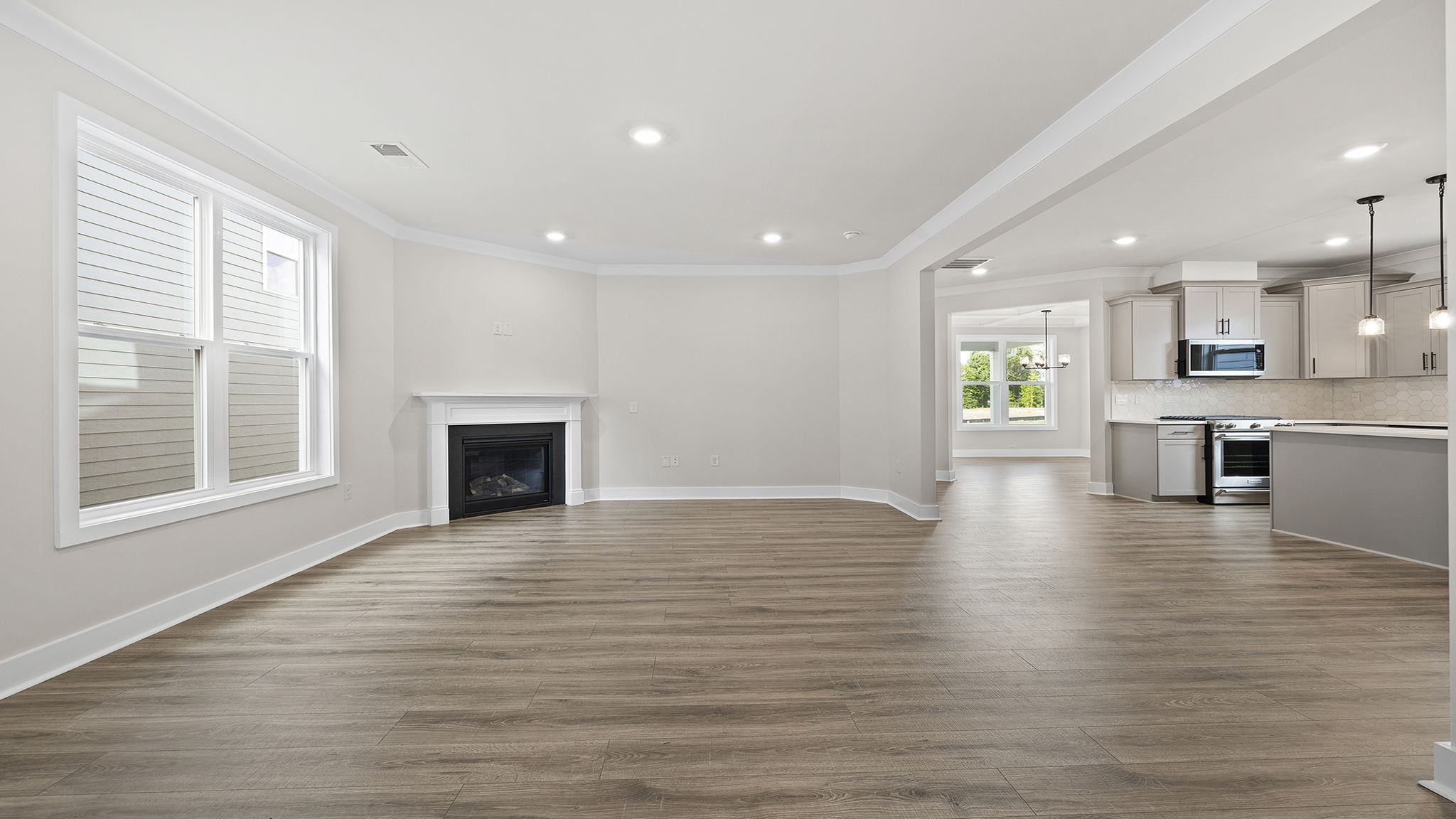 View of family room with large window and gas log fireplace.