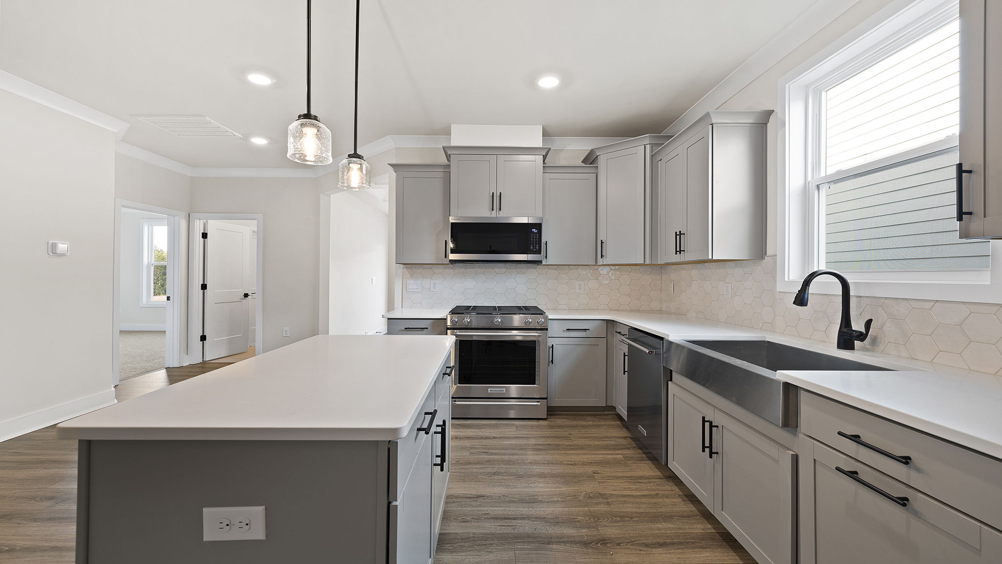 Kitchen and island with quartz countertops.