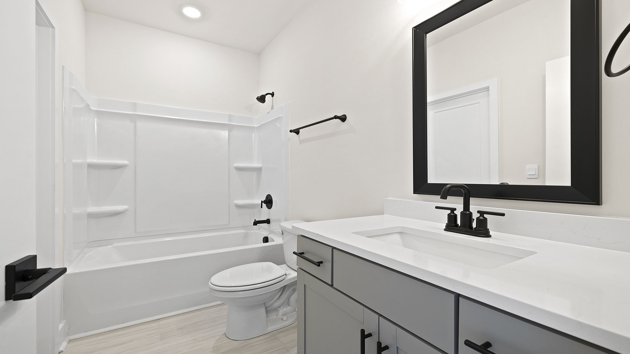 Bathroom with double vanity sink and bathtub.