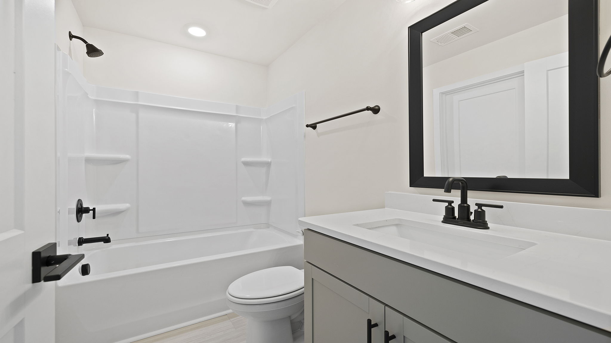 Bathroom with double vanity sink and bathtub.