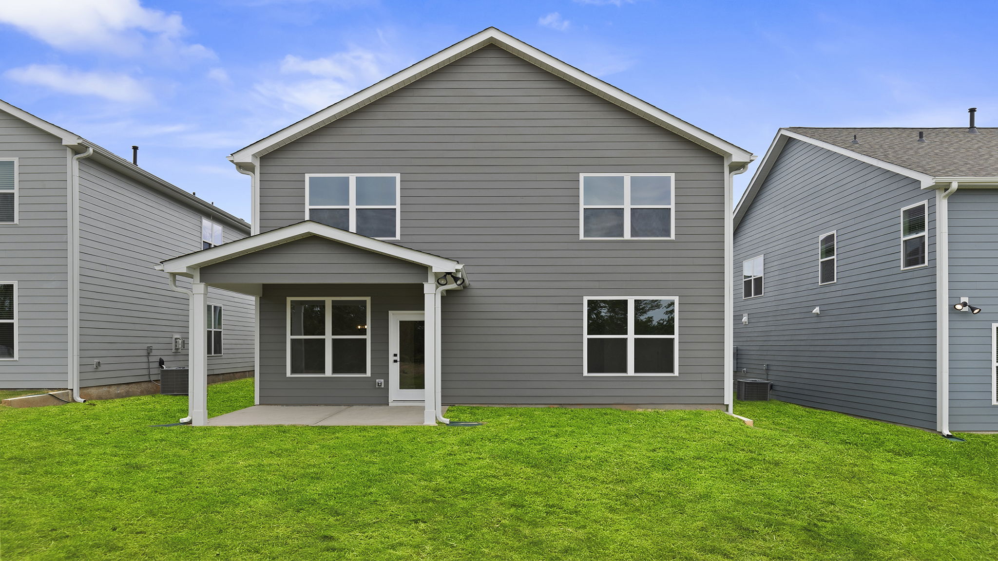 Back exterior of home with large backyard.