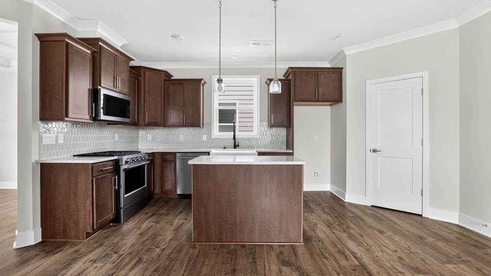 Kitchen with island and cabinets.