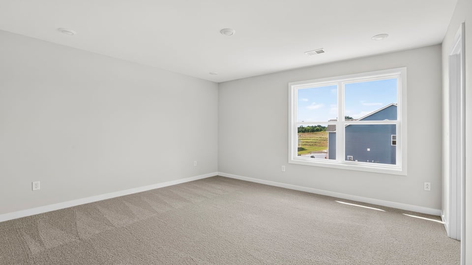 Bedroom with window and carpet.