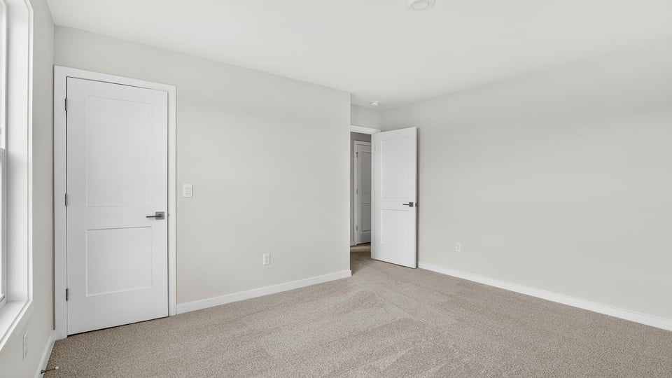 Bedroom with window and carpet.