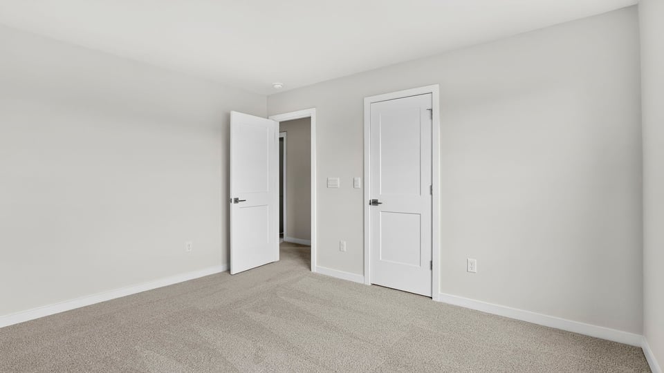Bedroom with window and carpet.