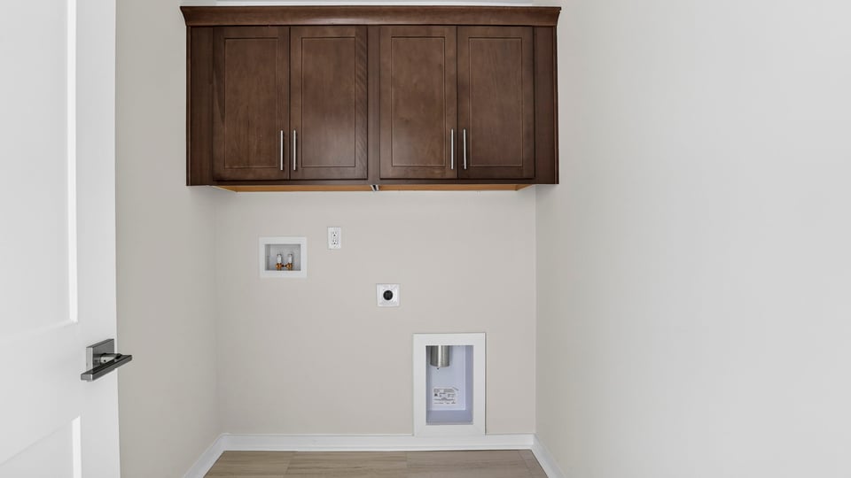 Laundry room with cabinets.