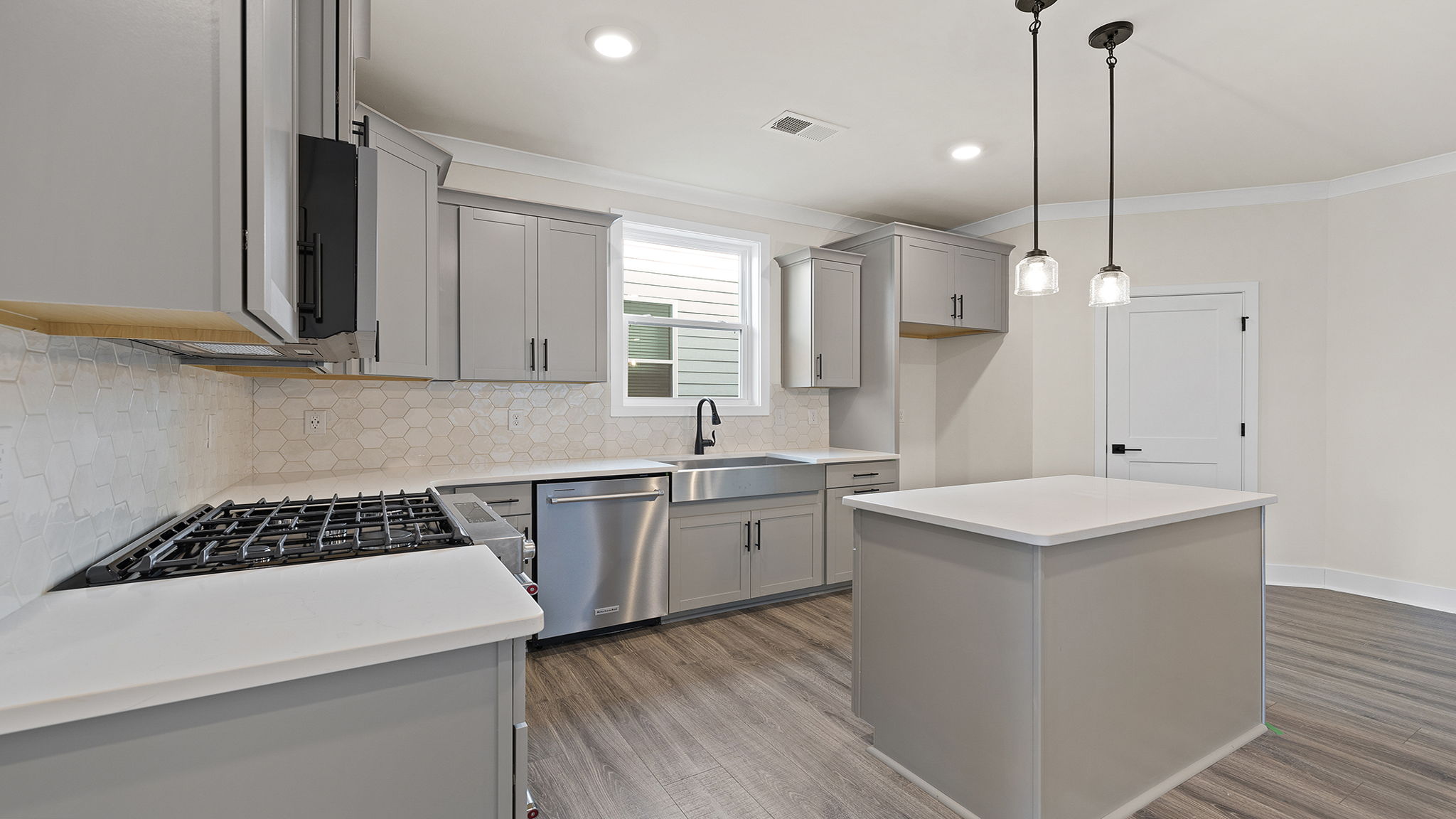 Kitchn with island and cabinets.