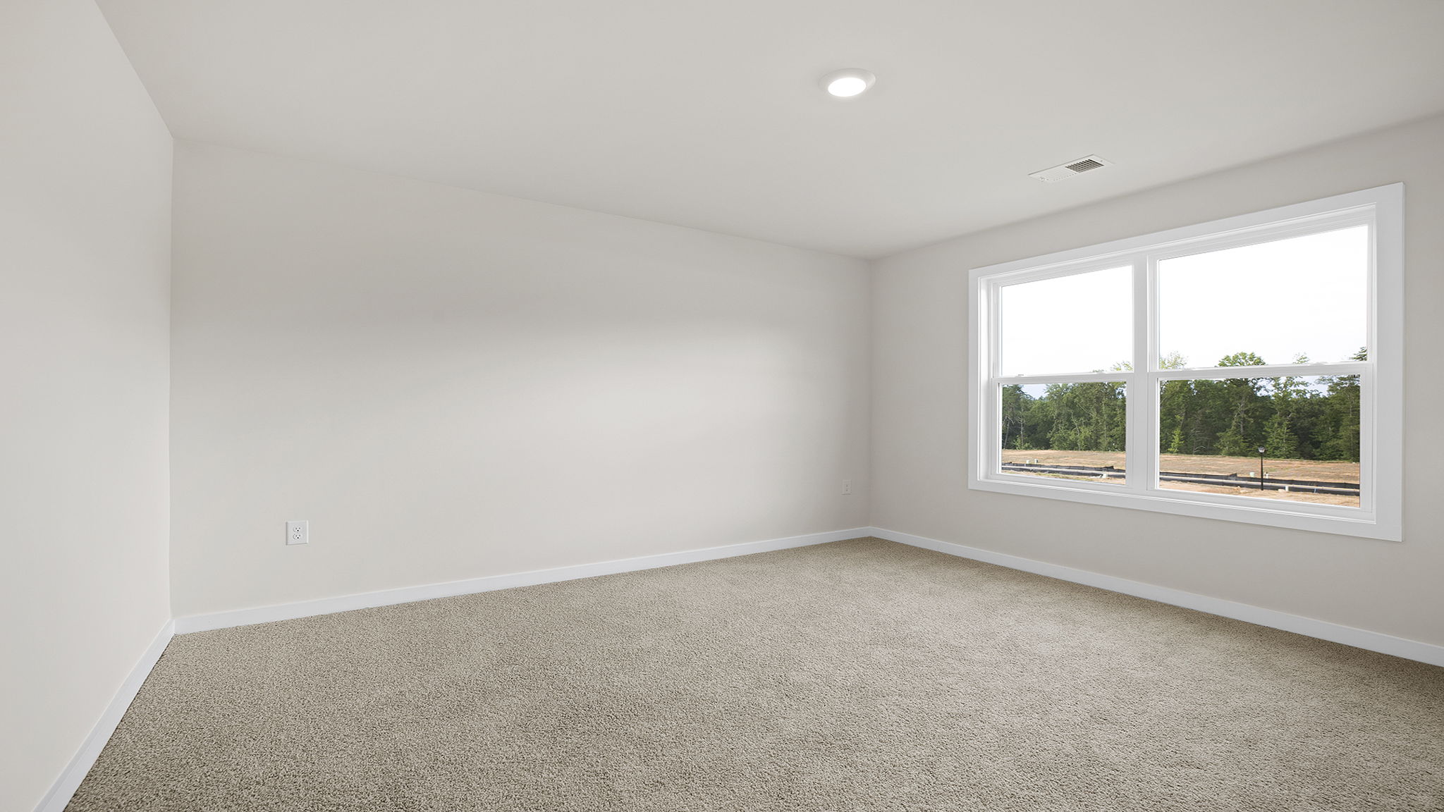 Bedroom with carpet and window.