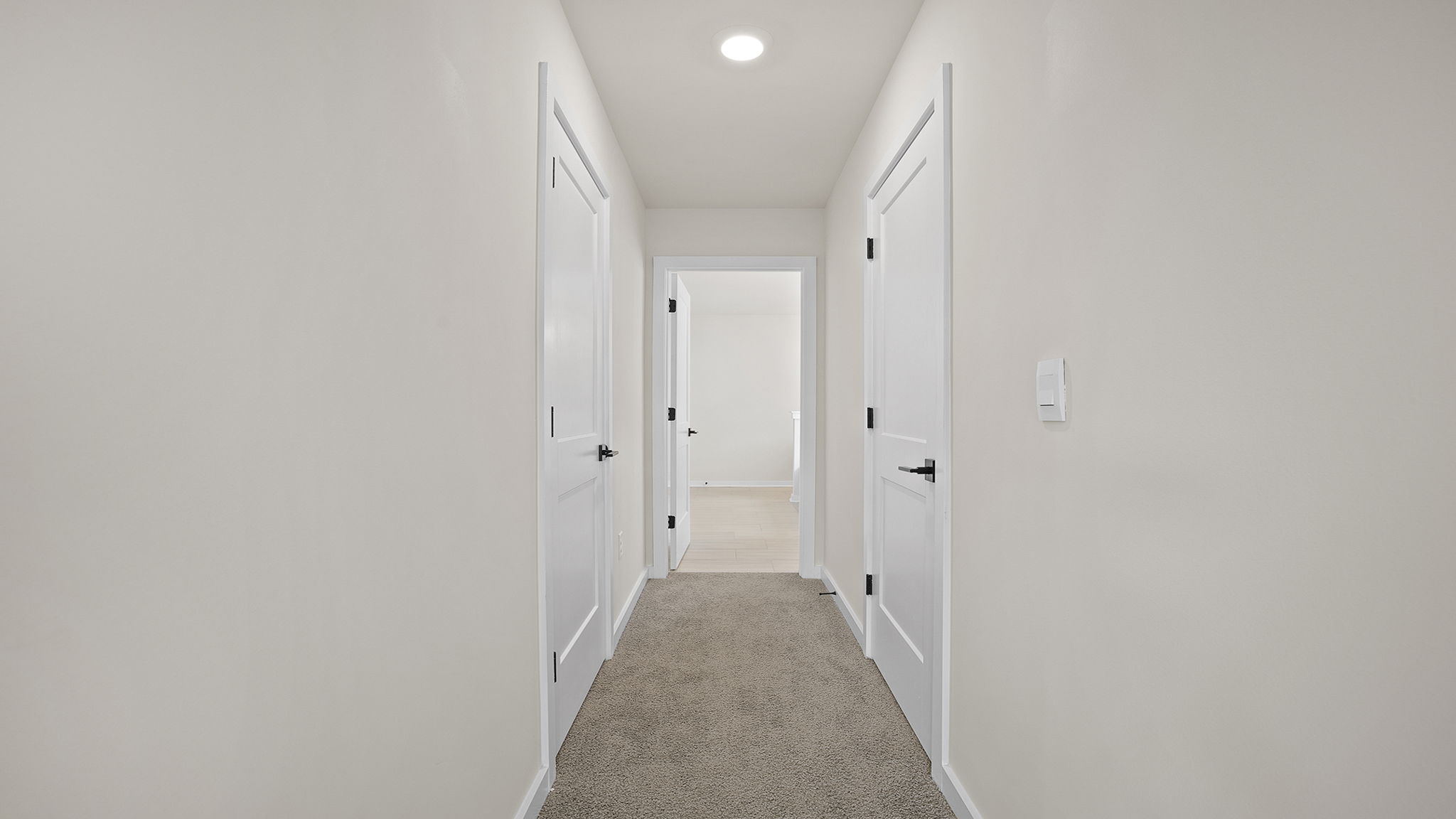 Primary bedroom hallway to closet and bathroom.