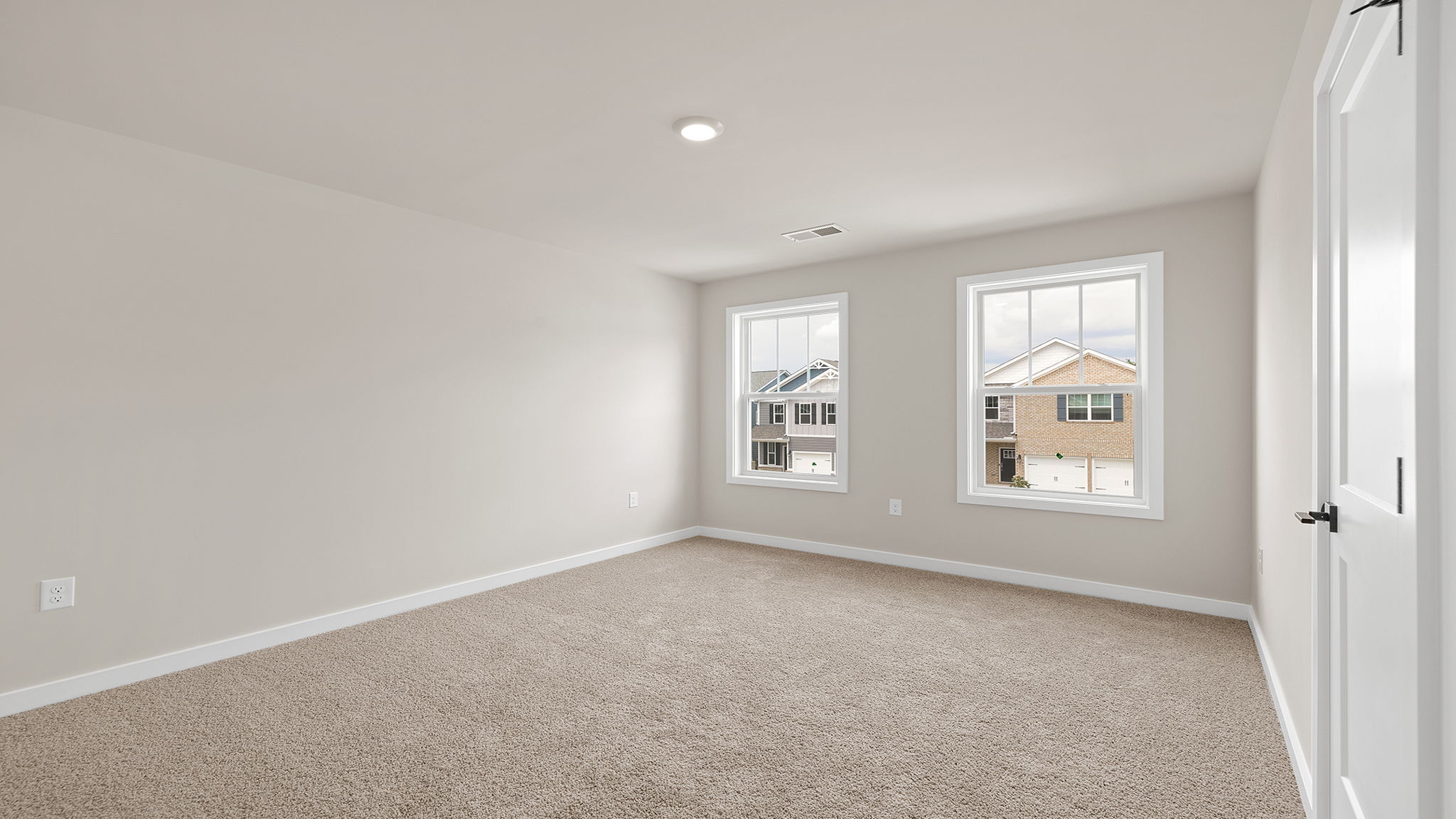Bedroom with carpet with window.