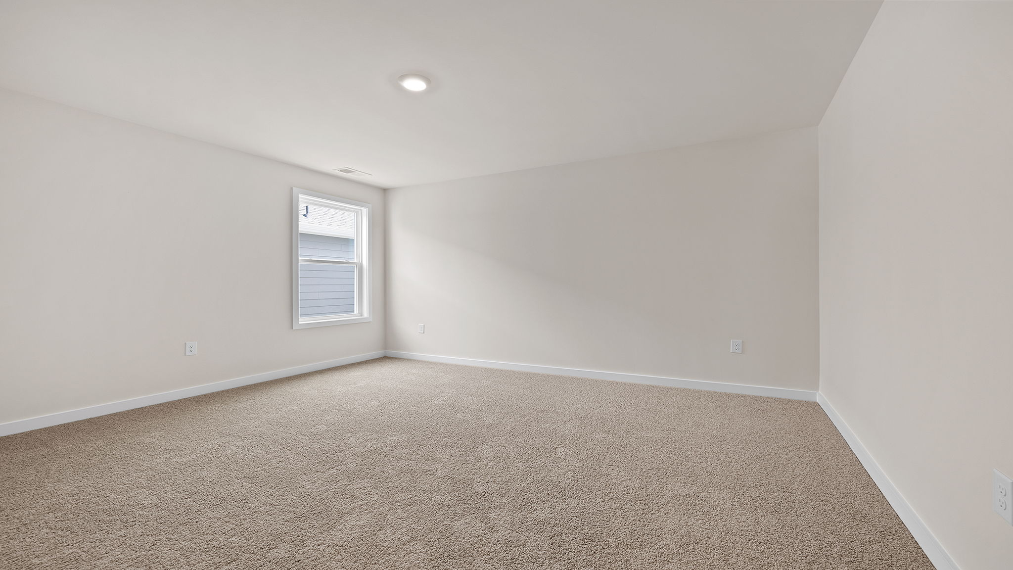 Bedroom with carpet with window.