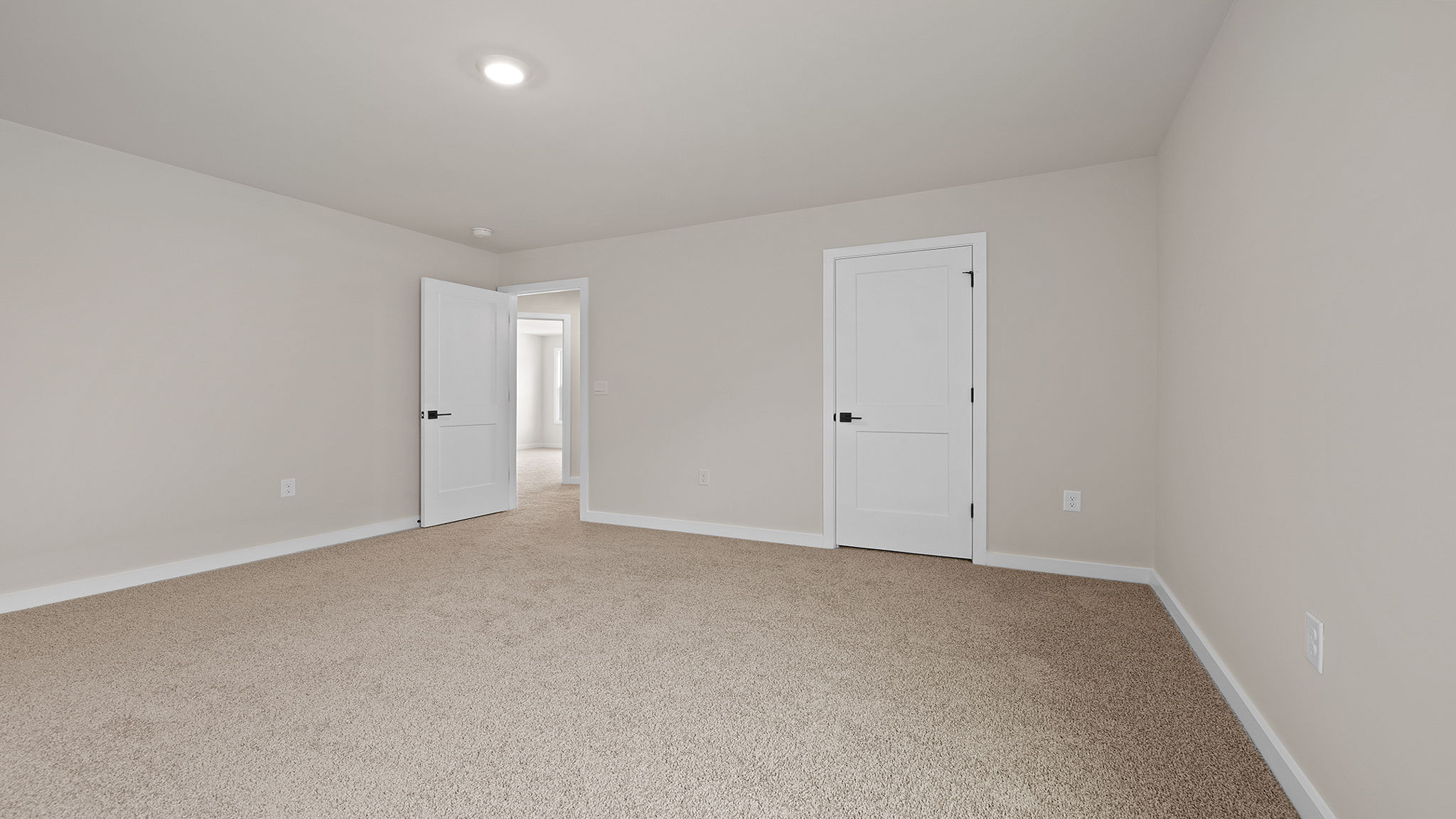 Bedroom with carpet with window.