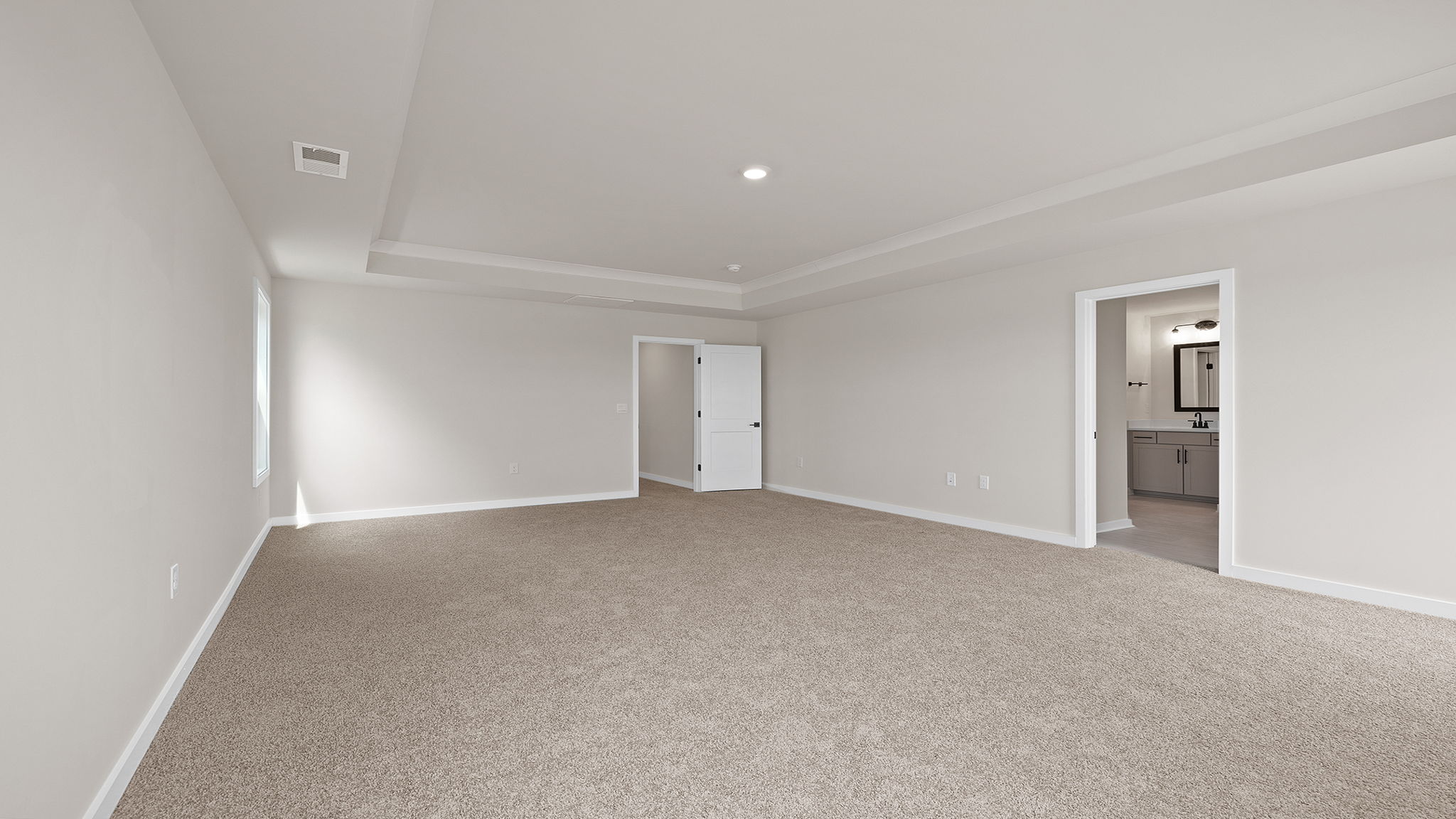 Bedroom with carpet with window.