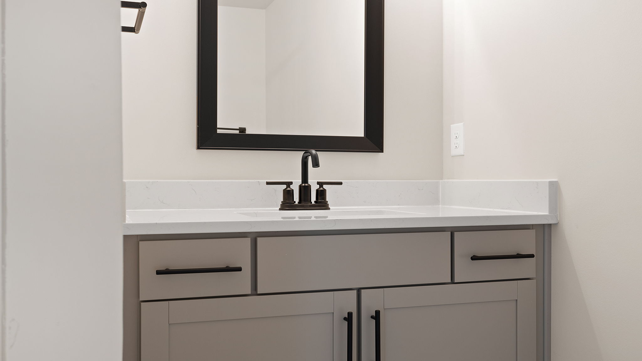 Bathroom with vanity and shower.