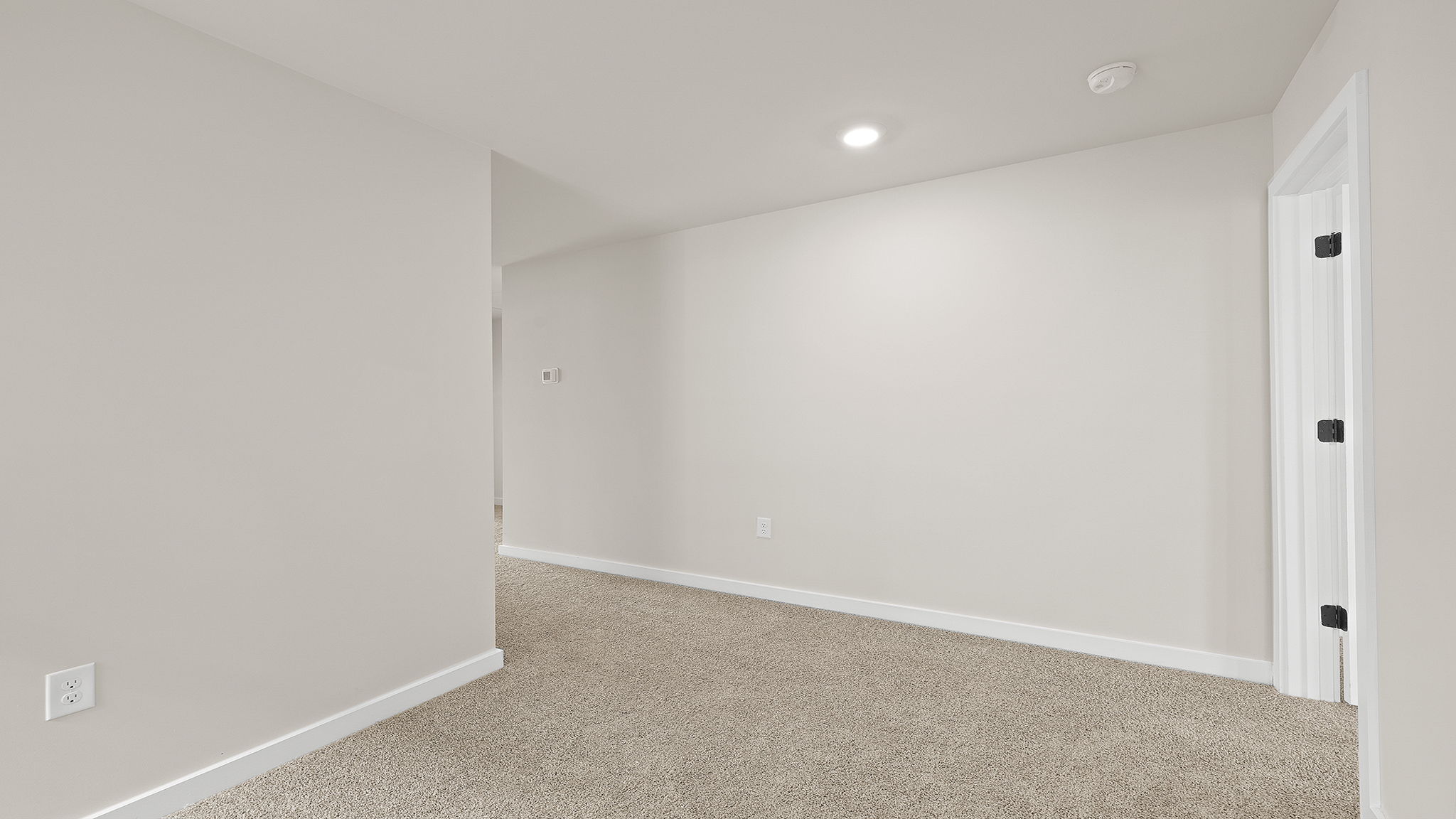 Hallway to bedrooms with carpet.